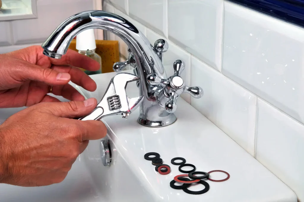 Plumber performing maintenance on a bathroom faucet in Deltona