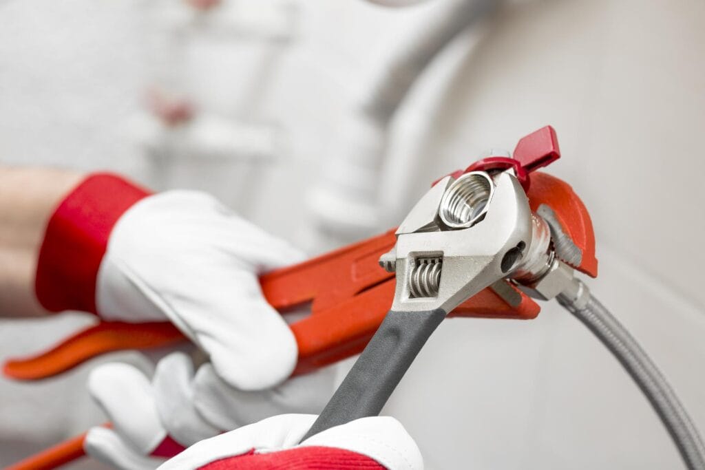 Plumber holding pipe wrenches for an emergency repair in Deltona