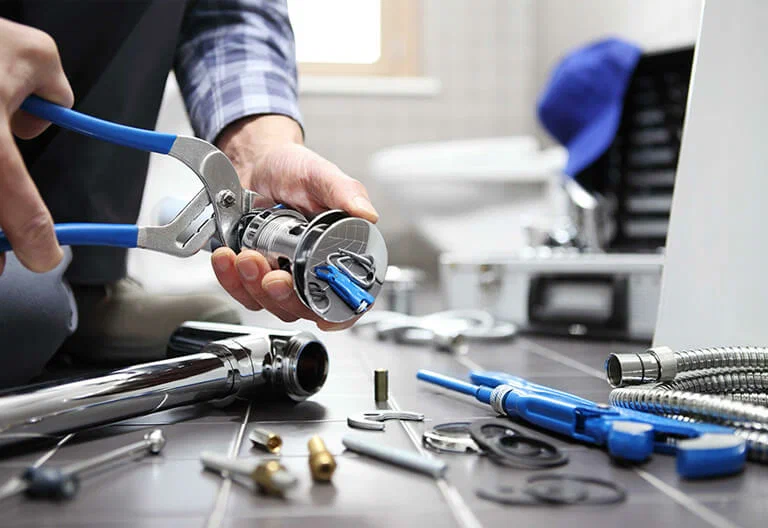 Technician repairing a plumbing fixture with professional tools in Deltona