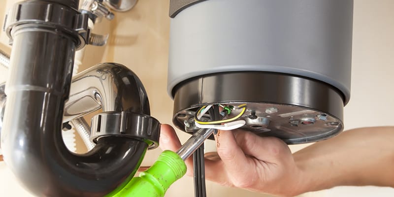 Technician repairing the heating element of a water heater in Deltona