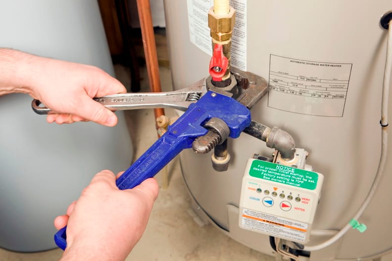 Plumber repairing a water heater valve in Deltona